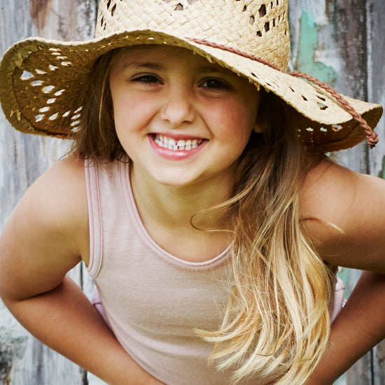 Little Girl smiles wearing Merino Tank, Pink Peach Blossom in the colour Vest Top by Smalls